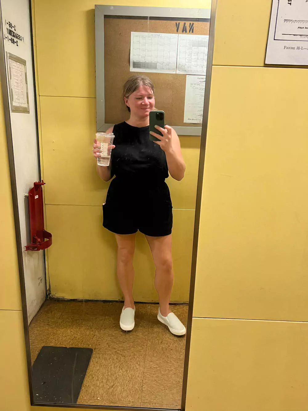 Katie taking a mirror selfie inside the Battleship Missouri Memorial on Oʻahu, capturing part of the ship’s interior with historic naval details in the reflection.