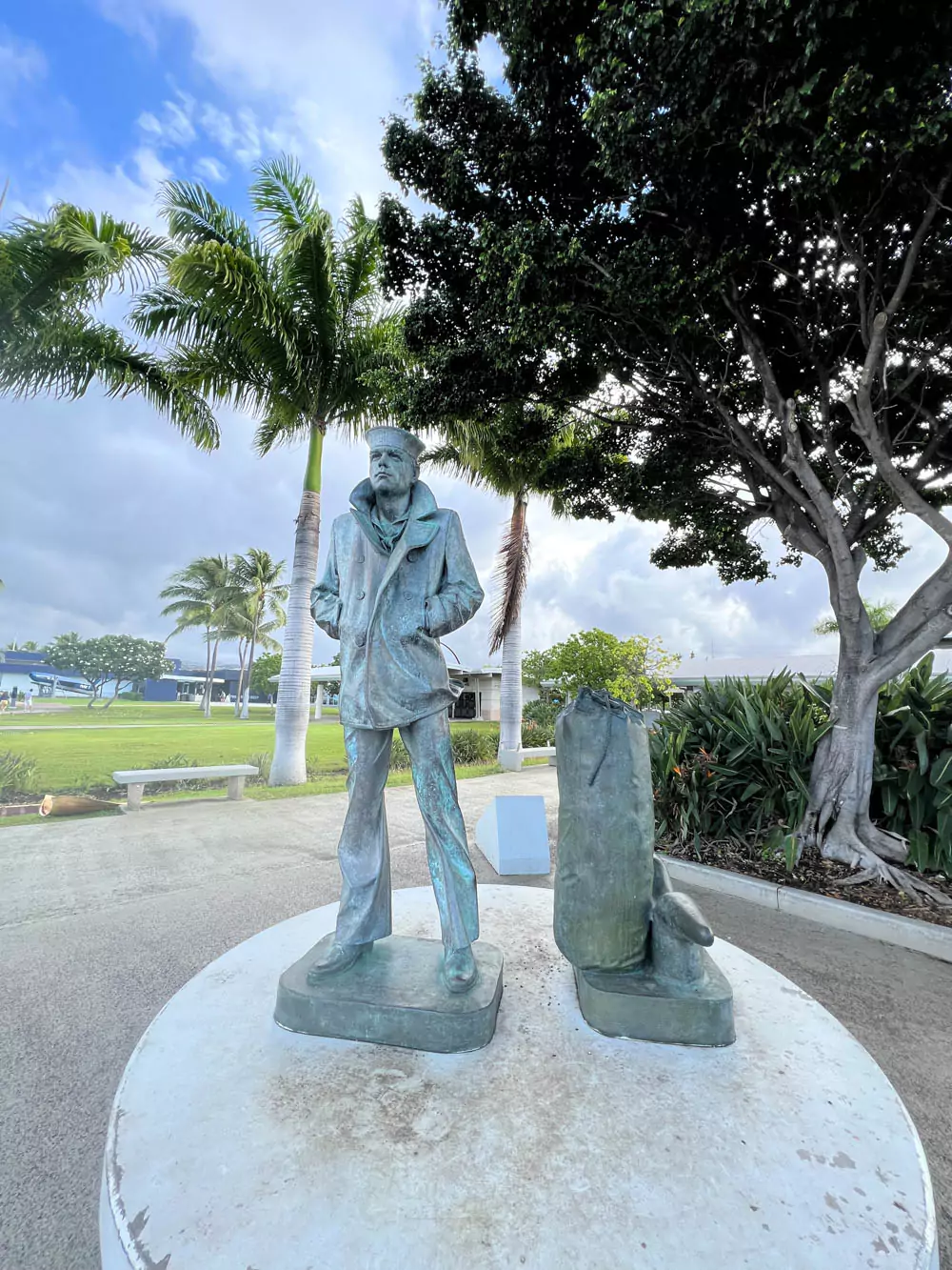 Lone Sailor Statue at Pearl Harbor, depicting a bronze U.S. Navy sailor standing beside a sea bag, symbolizing honor, service, and the sacrifices of naval personnel.