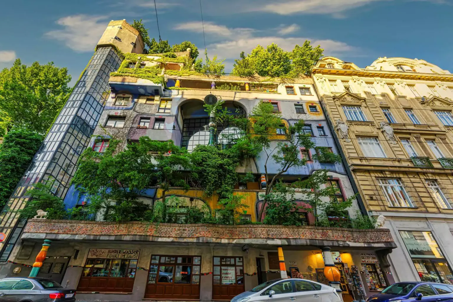 Hundertwasser House in Vienna, Austria, a vibrant and whimsical apartment building with uneven lines, colorful mosaic walls, trees growing from balconies, and an imaginative blend of nature and architecture by artist Friedensreich Hundertwasser.