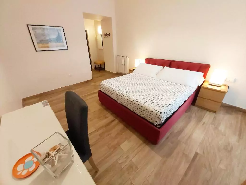 B&B Floridiana in Naples, Italy, showcasing a cozy guest room with soft lighting, elegant bedding, and classic decor, located near the Villa Floridiana in the quiet Vomero district