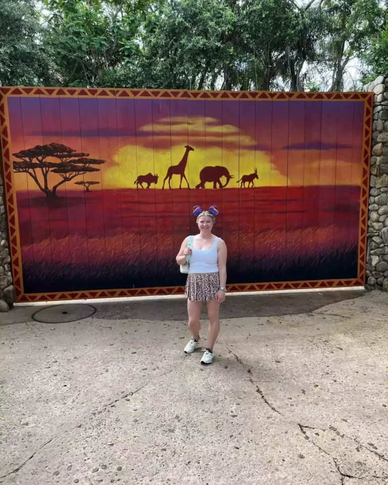 katie at disneyanimal kingdom with safari animals mural