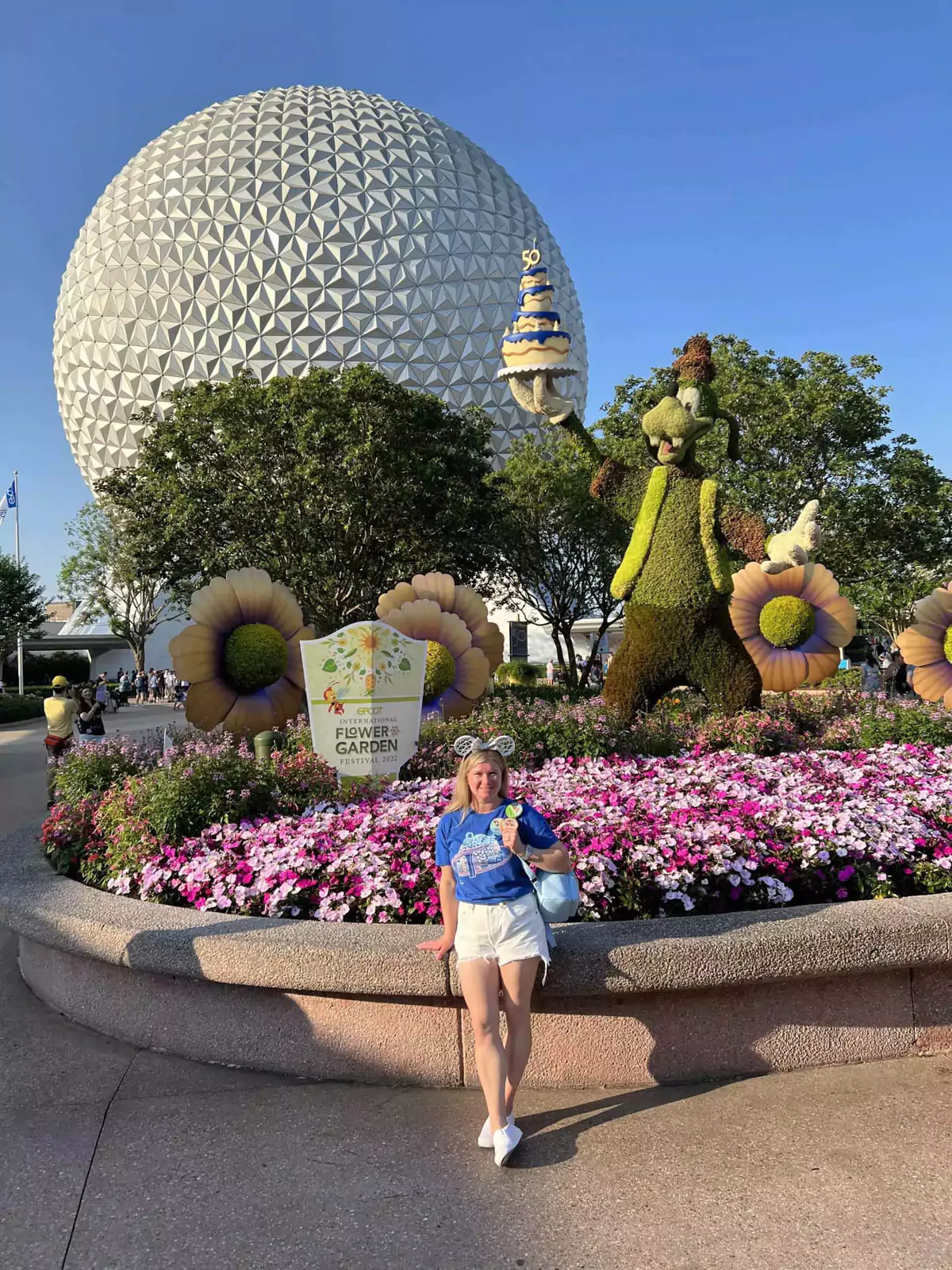 katie at epcot with goofy topiary for flower and garden festival