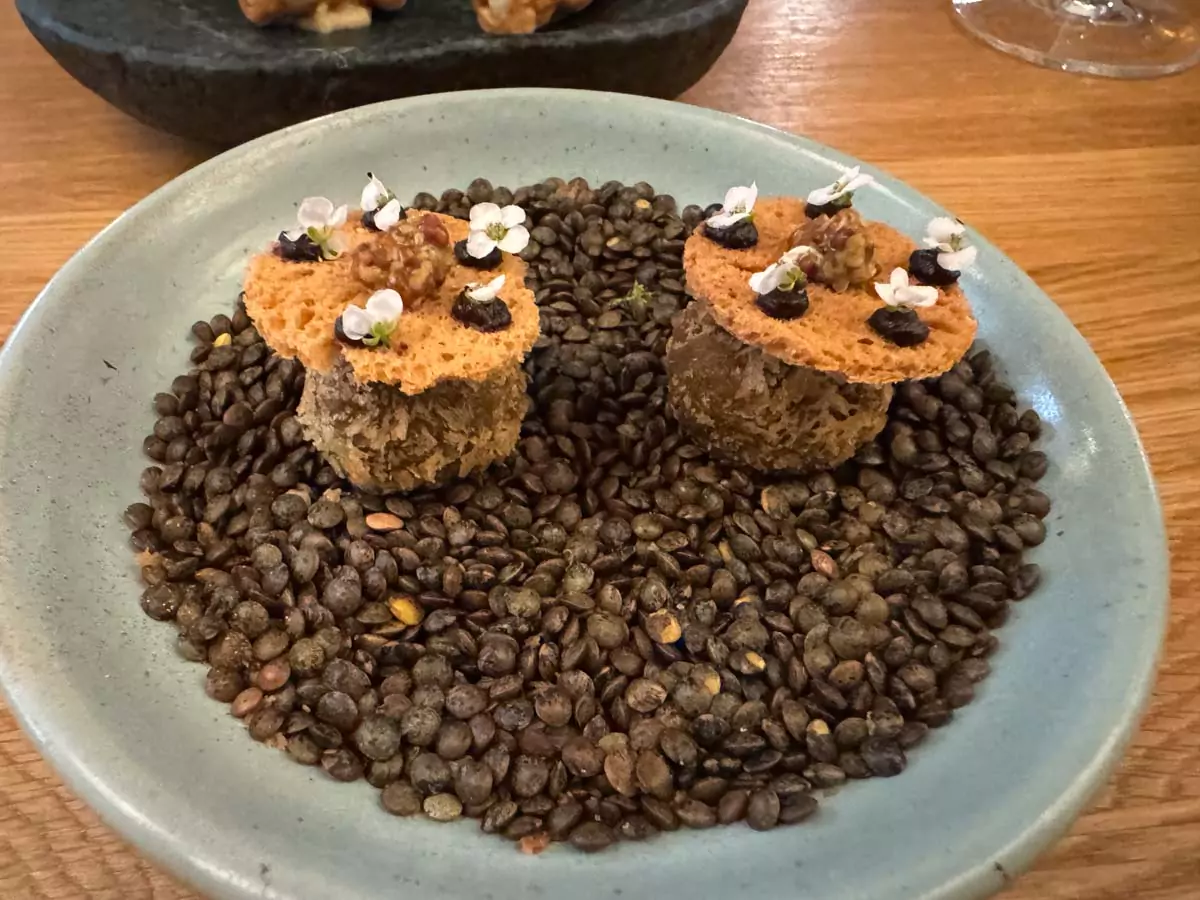 Amuse-bouche served at Auberge Nicolas Flamel in Paris, France, featuring a small, artistically plated bite to begin the fine dining experience in one of the city’s oldest historic buildings.