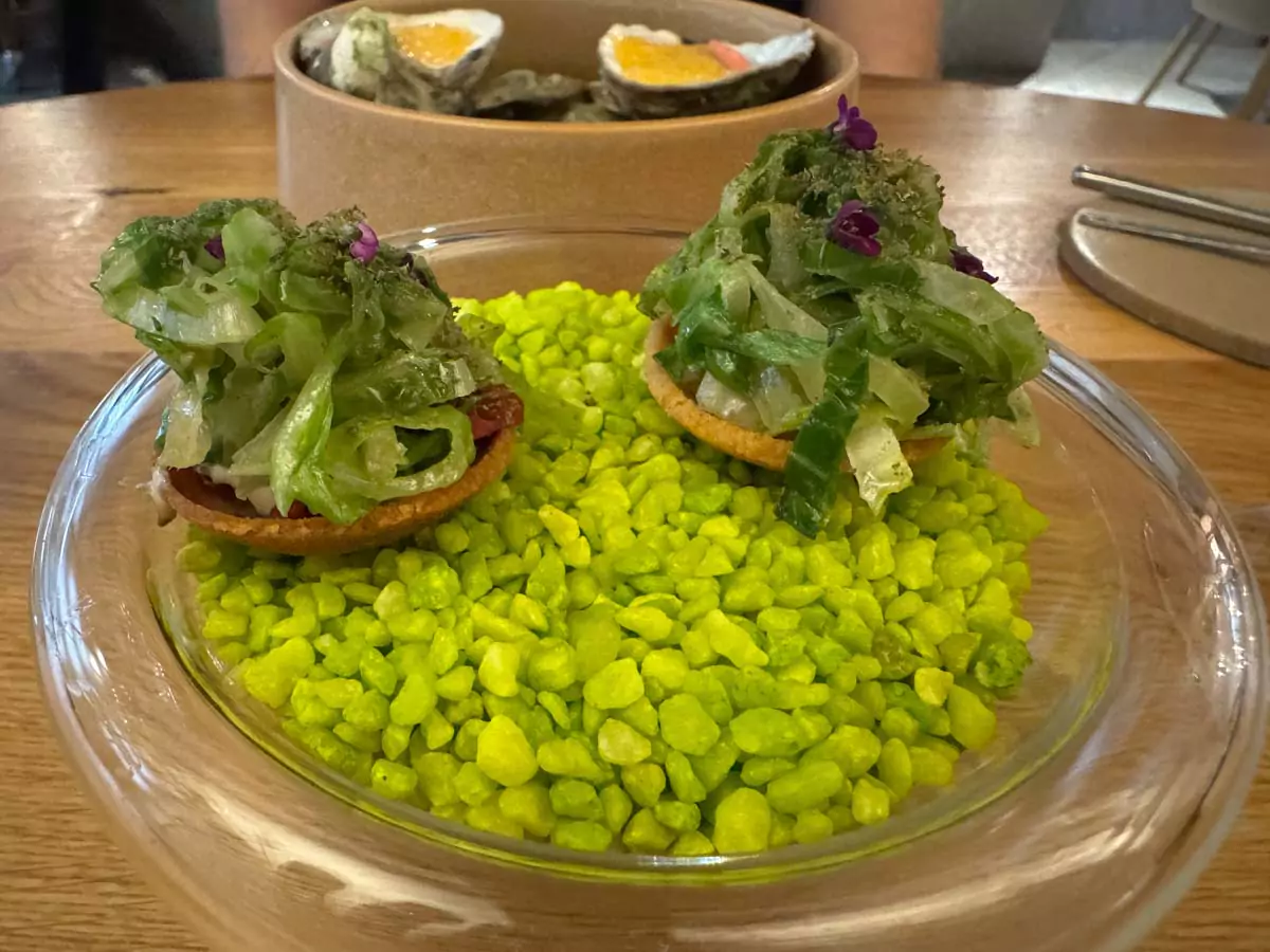 Amuse-bouche served at Auberge Nicolas Flamel in Paris, France, featuring a small, artistically plated bite to begin the fine dining experience in one of the city’s oldest historic buildings.