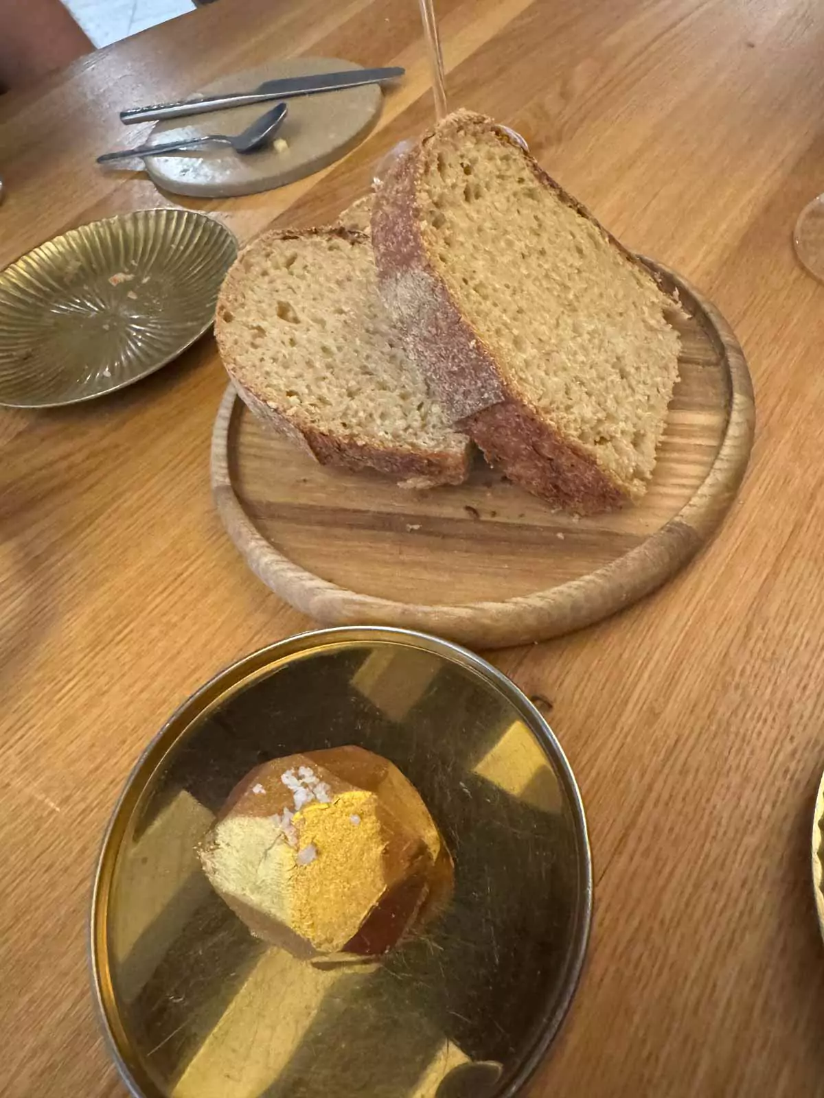 Freshly baked bread served with butter at Auberge Nicolas Flamel in Paris, France, presented in a simple yet elegant style as part of the fine dining lunch experience.