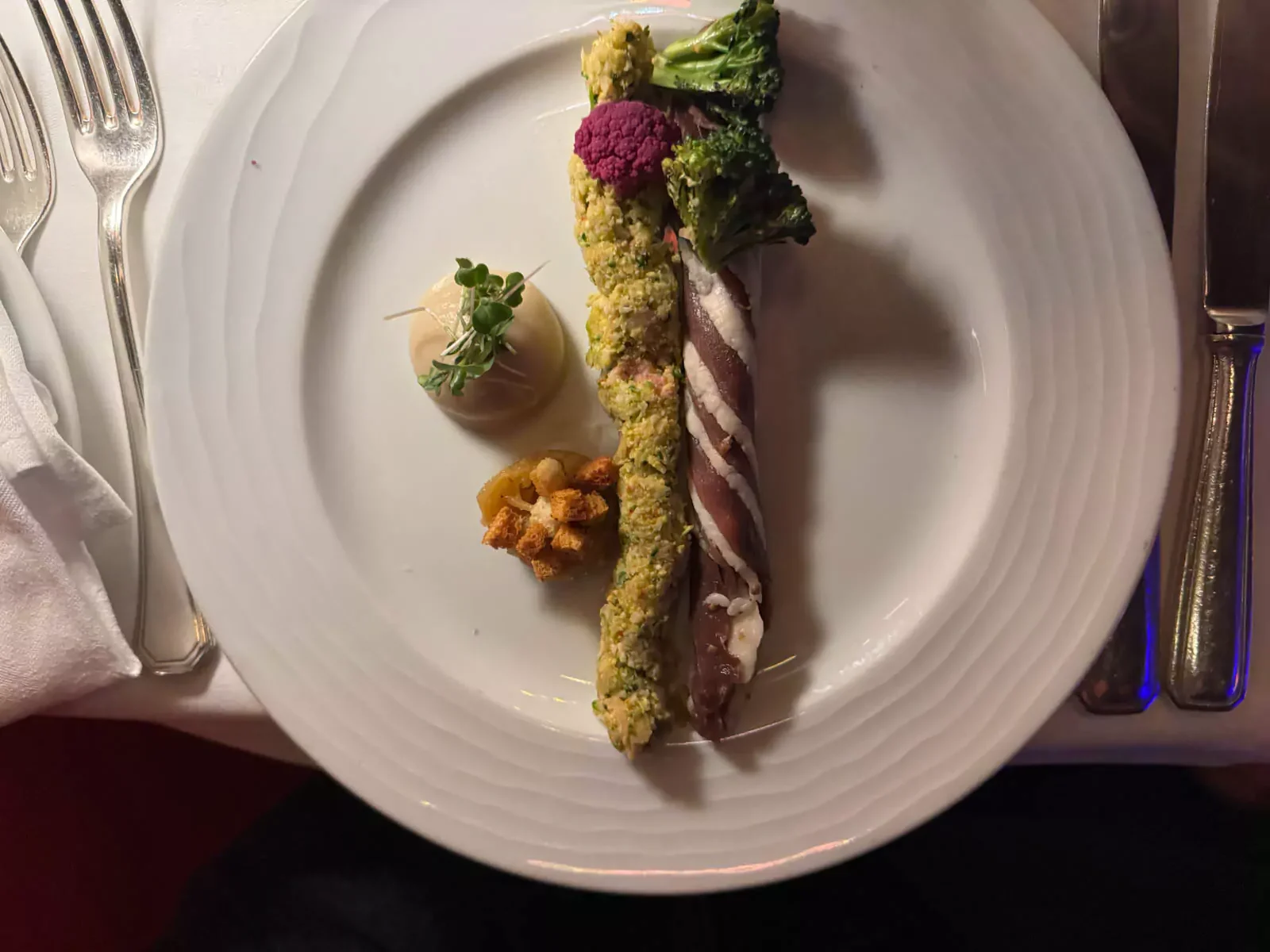 Starter of homemade duck ham served at the Moulin Rouge in Montmartre, Paris, delicately sliced and plated with seasonal accompaniments for a refined French appetizer experience.