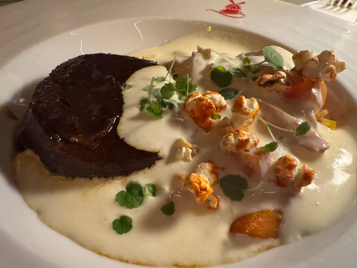 Slow-braised beef cheek served as a main course near the Moulin Rouge in Montmartre, Paris, presented with a rich sauce and garnished for a refined and hearty French dining experience.