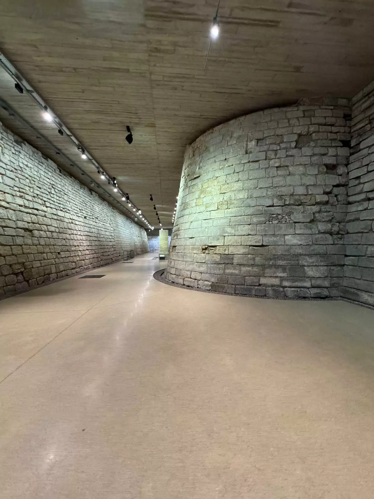 Medieval remains beneath the Louvre Museum in Paris, France, showcasing the original stone foundations and ancient walls of the former fortress — a hidden historic layer
