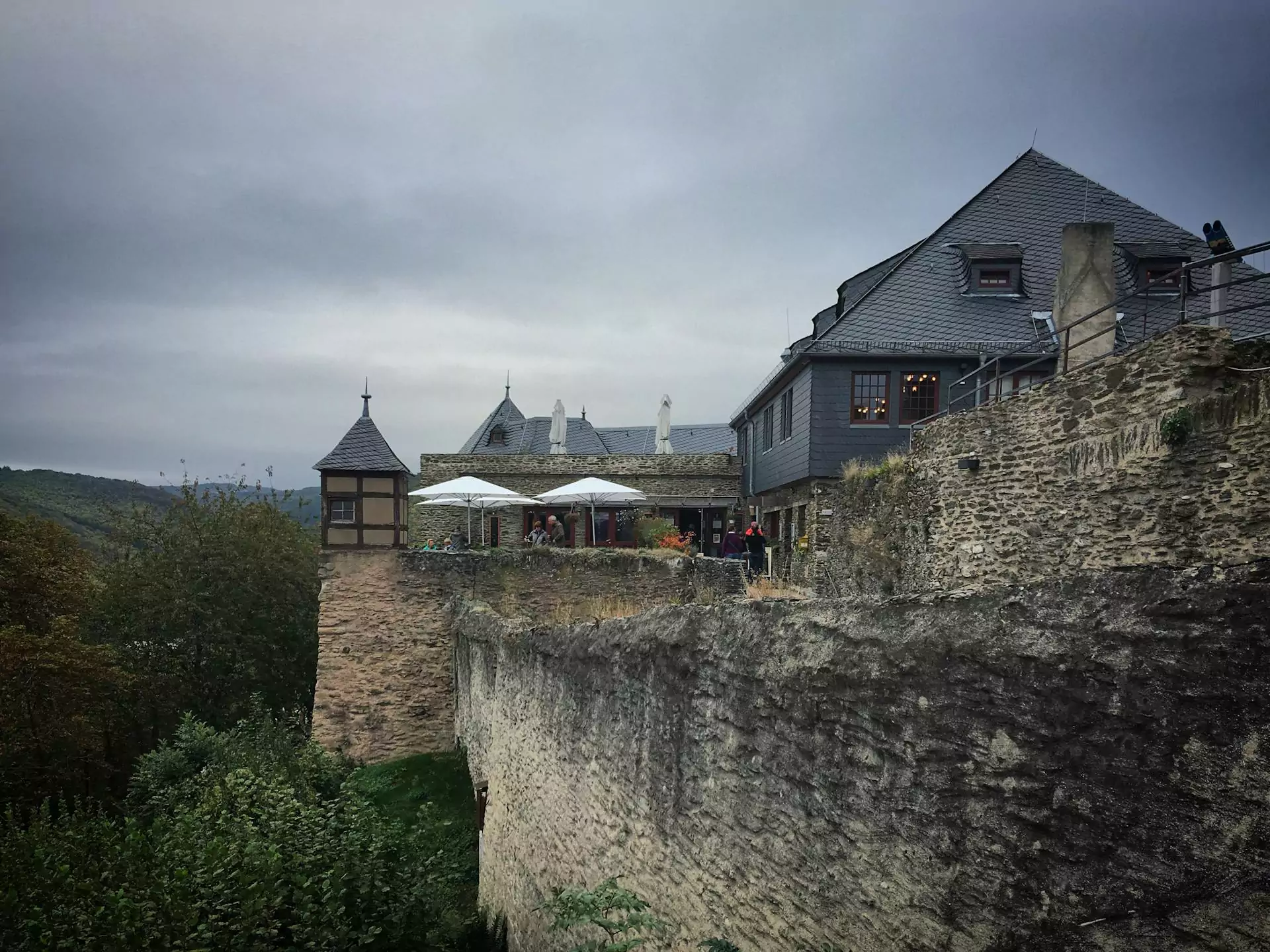 Marksburg Castle in Germany, a well-preserved medieval fortress perched above the Rhine River, featuring white stone walls, defensive towers, and commanding views over the surrounding valley.