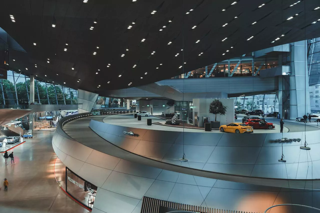 Exterior view of the BMW Museum and BMW Welt in Munich, Germany, with the museum’s iconic circular building and the futuristic architecture of BMW Welt nearby, showcasing innovation and automotive history.
