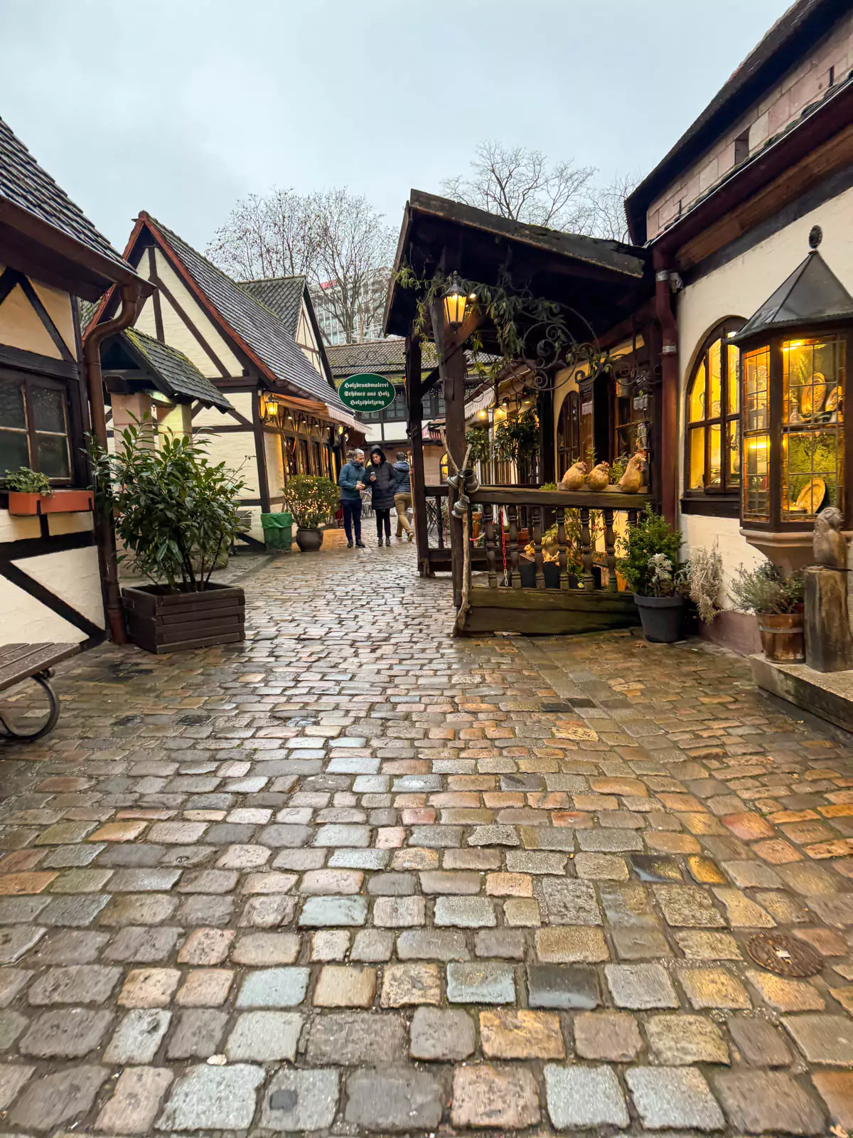 Quaint shops at Handwerkerhof in Nuremberg, Germany, housed in traditional half-timbered buildings within the old city walls. Artisans sell handcrafted goods like pottery, leather, and jewelry in this charming medieval-style village.