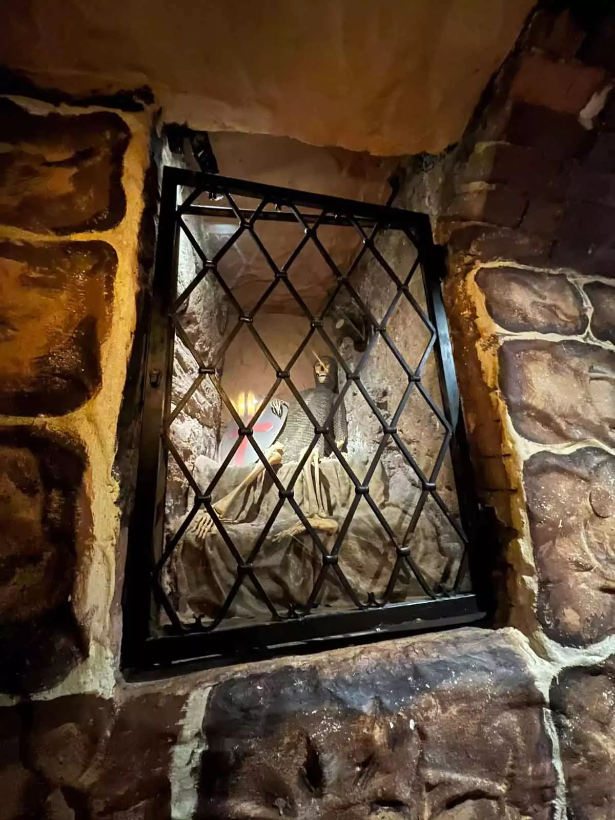 A small decorative skeleton placed on the stone stairway descending into Im Keller, a historic cellar or basement in Nuremberg. The spooky figure adds a playful touch to the old, dimly lit staircase.
