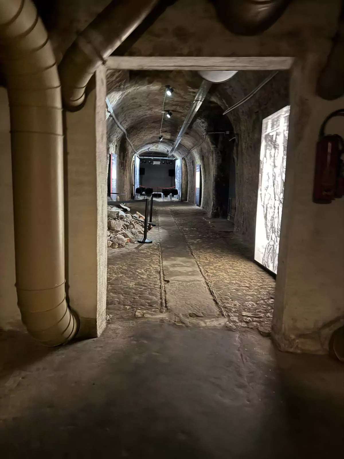 Underground art bunker in Nuremberg, Germany, featuring dimly lit stone tunnels and climate-controlled chambers that once protected valuable artwork during World War II.