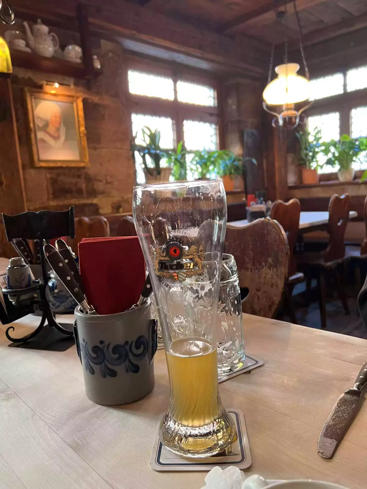 Traditional German beers served on a wooden table at Zum Gulden Stern in Nuremberg, with frosty steins filled with golden lager and rich amber brews, capturing the cozy tavern atmosphere.
