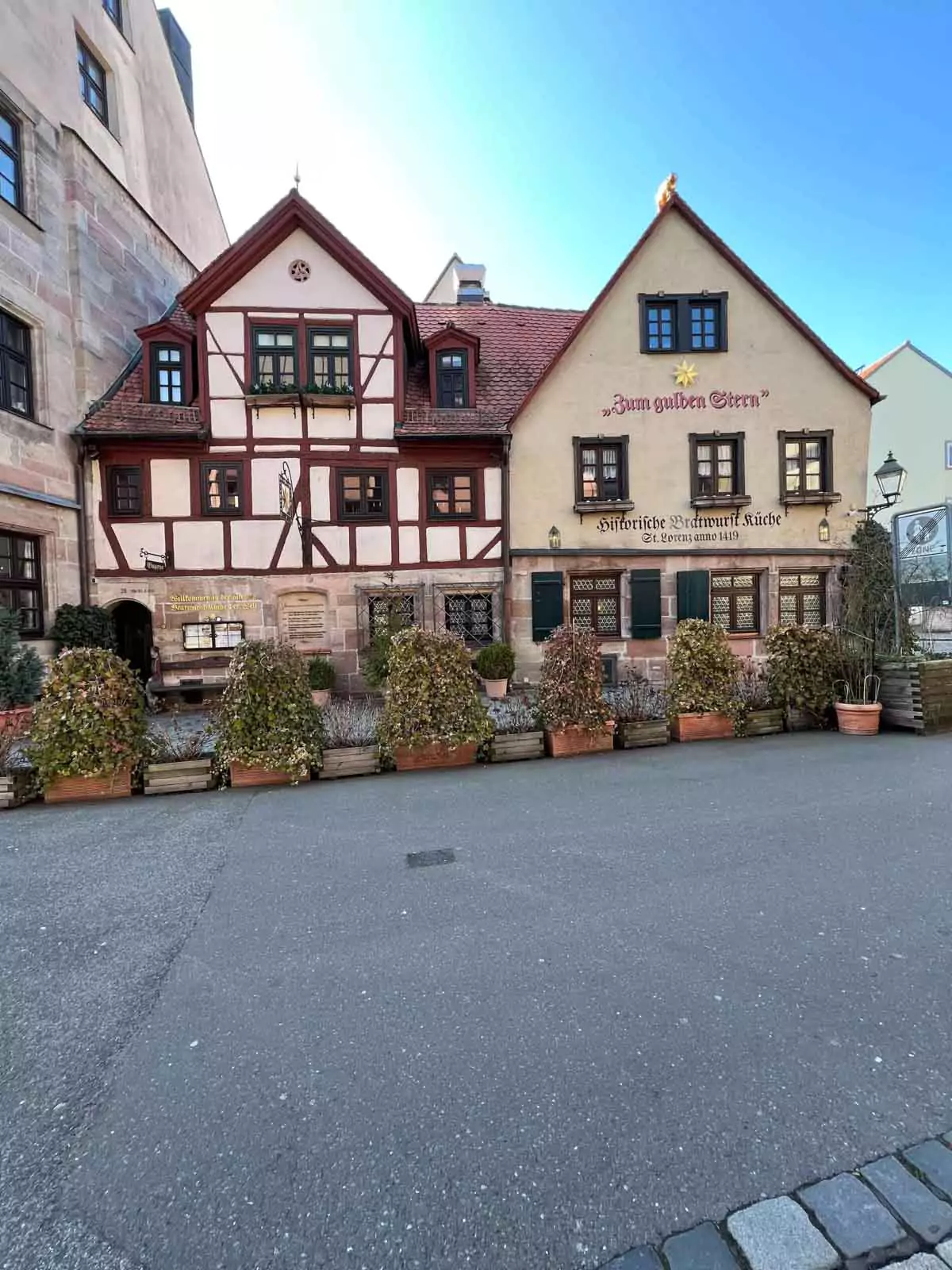 Exterior of Zum Gulden Stern in Nuremberg, Germany—one of the world’s oldest bratwurst restaurants—featuring a historic half-timbered facade, red shutters, and traditional signage in Nuremberg’s Old Town.