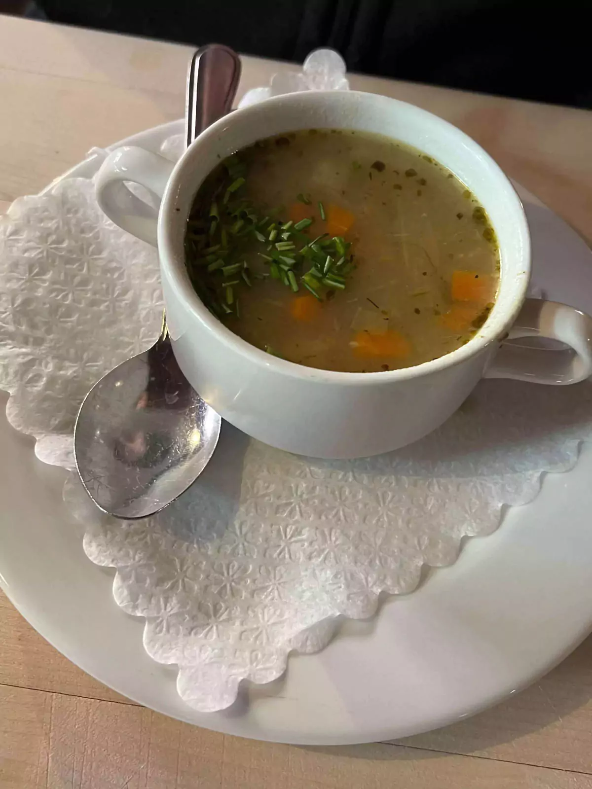 Hearty vegetable soup served at Zum Gulden Stern in Nuremberg, Germany, featuring a warm broth filled with diced carrots, potatoes, and herbs, presented in a rustic bowl.