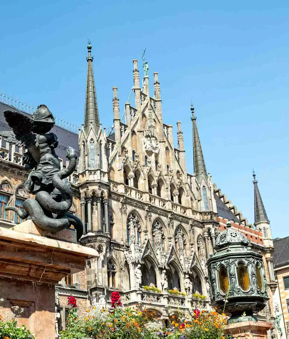 Intricate Gothic architectural details on the New Town Hall (Neues Rathaus) in Marienplatz, Munich, Germany, featuring pointed arches, spires, statues, and ornate stone carvings.