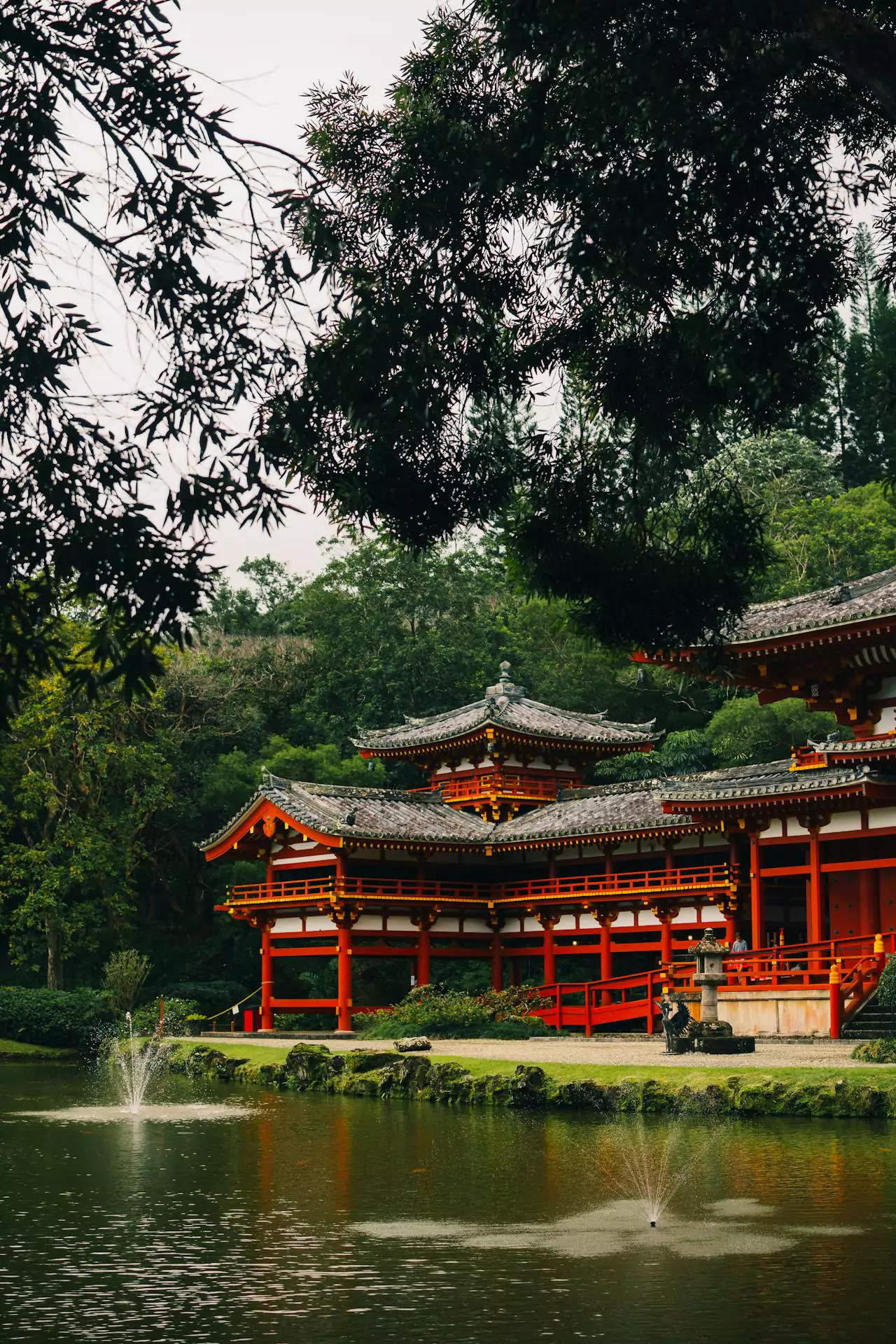 Byodo-In Temple in Kāneʻohe, Hawaii, a red-lacquered Buddhist temple set against the lush Koʻolau Mountains, surrounded by koi ponds, manicured gardens, and peaceful greenery.