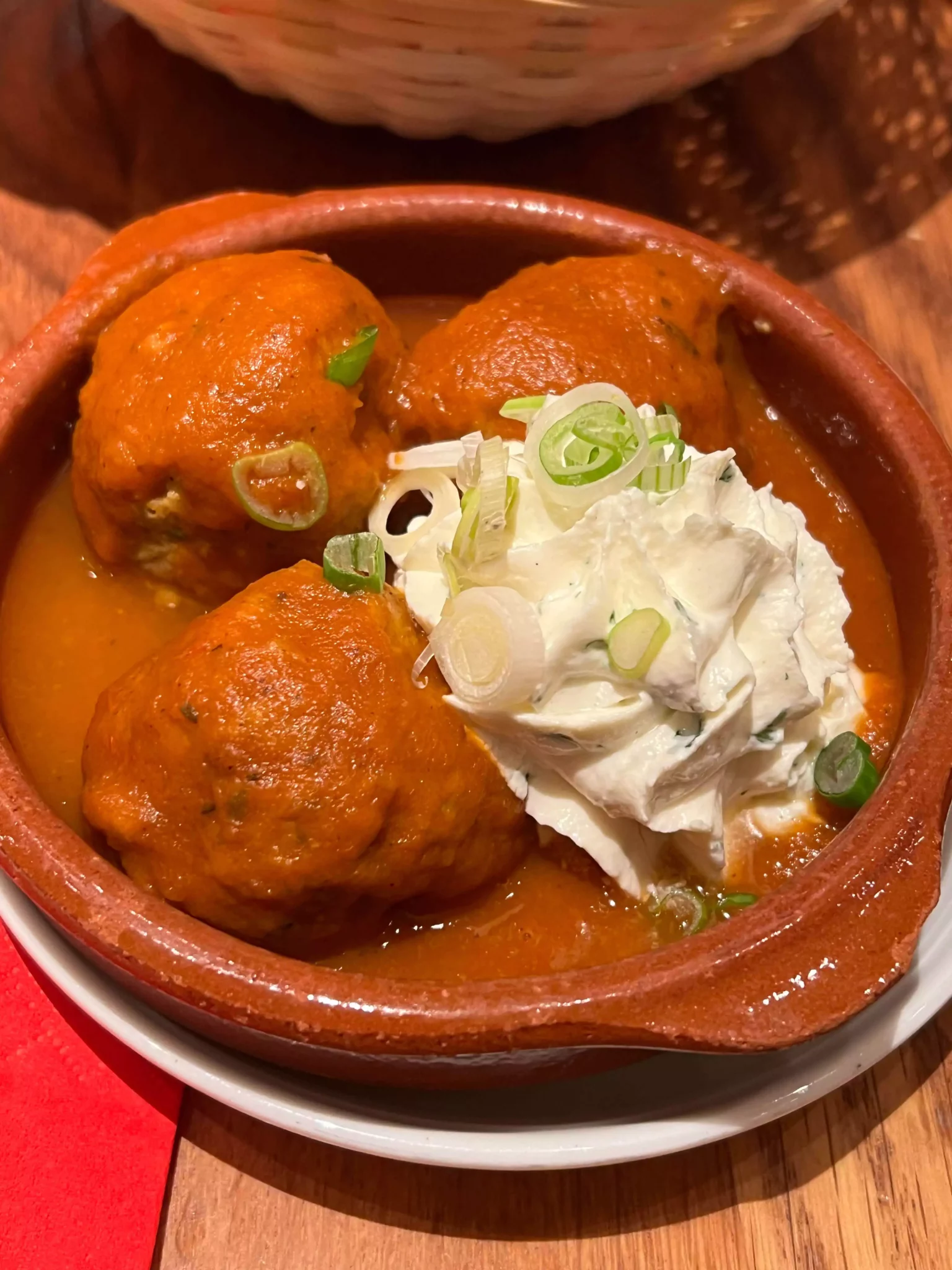 Homemade meatballs in spicy tomato sauce with herb cream cheese