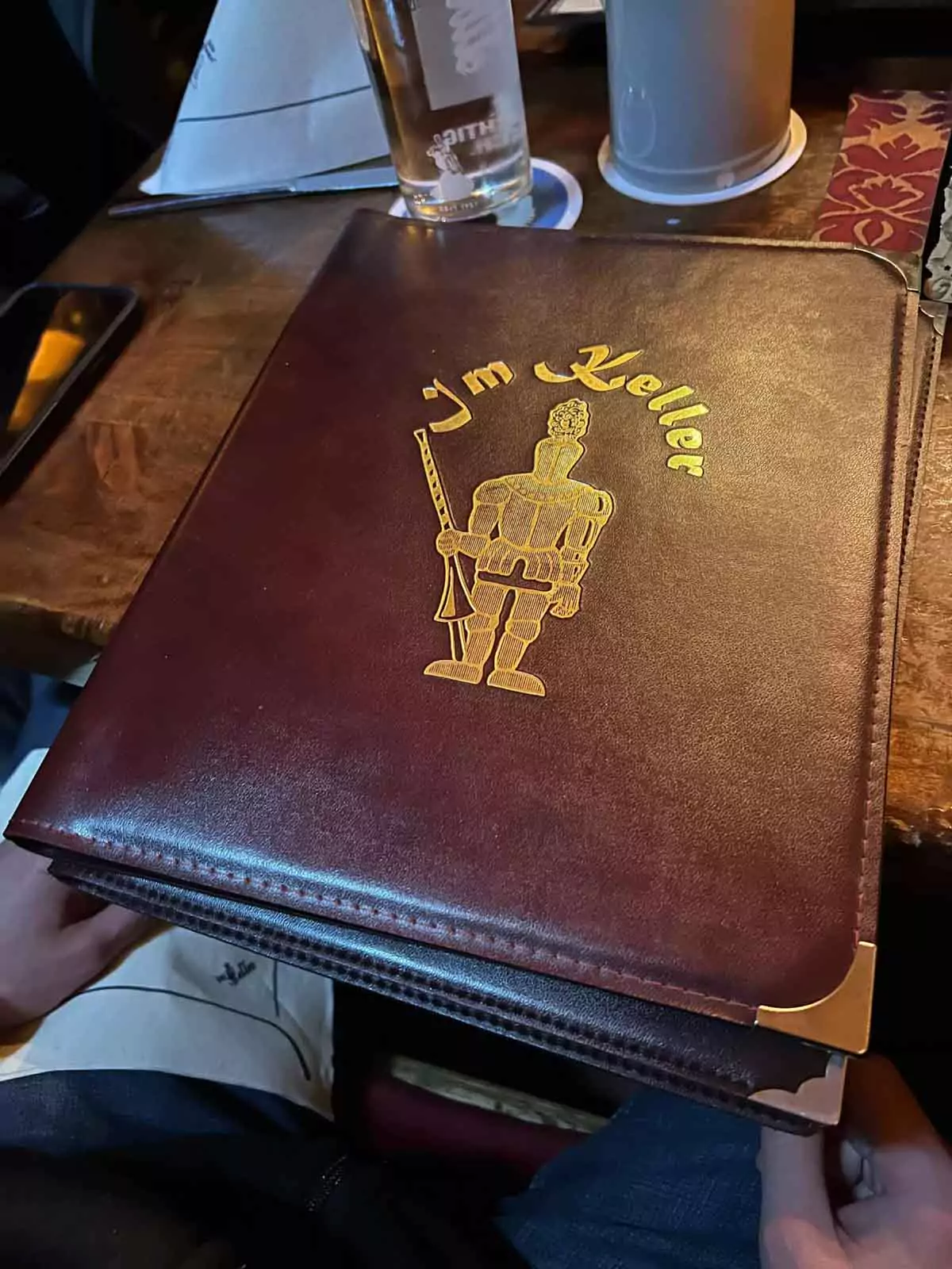 Menu from Im Keller restaurant in Nuremberg, Germany, featuring traditional Franconian dishes, sausages, schnitzel, and regional beer offerings, presented in a rustic and cozy dining setting.