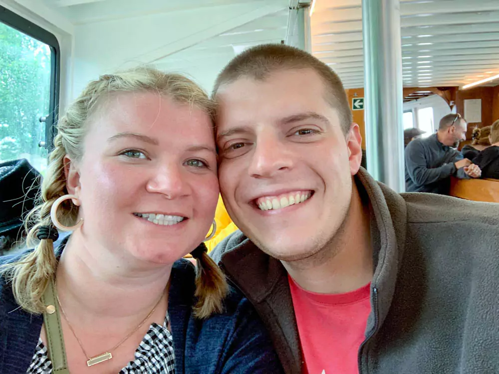 Katie and Zack riding a water taxi to Burano, smiling and enjoying the scenic ride across the lagoon 