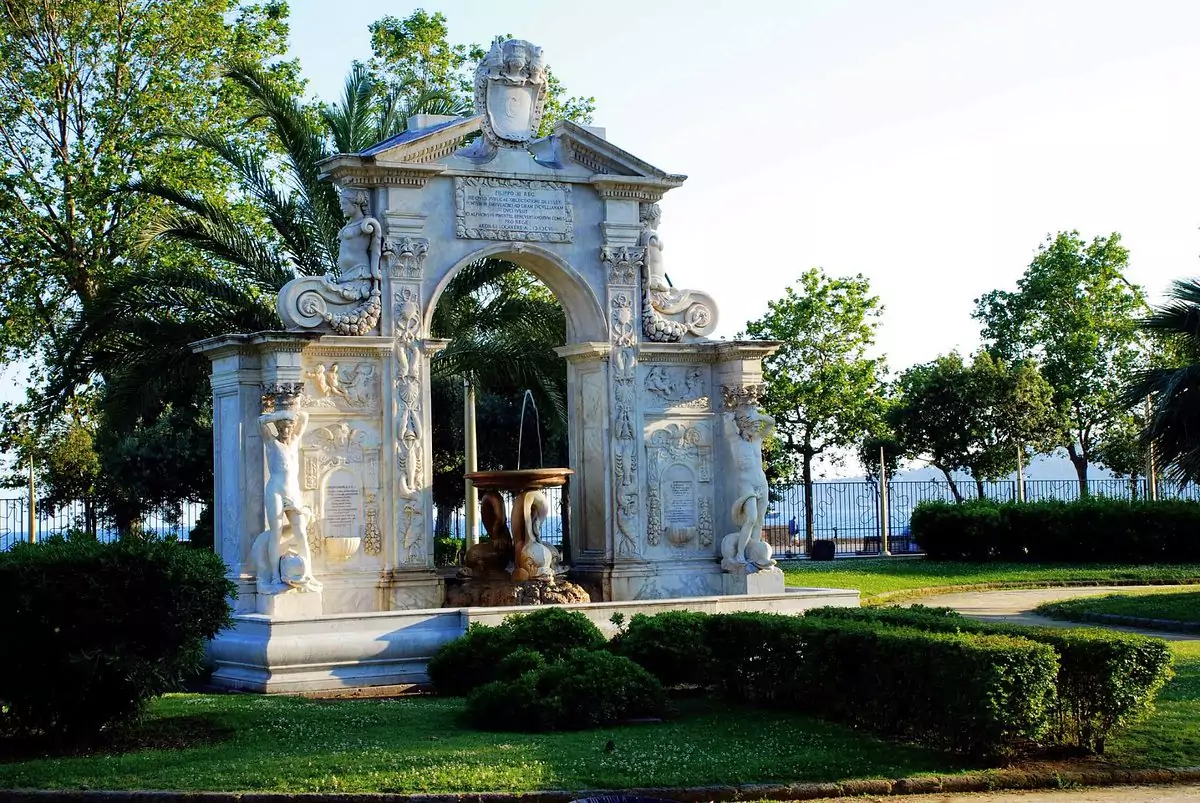Villa Comunale in Naples, Italy, a historic public park featuring wide walking paths, palm trees, fountains, and shaded benches, offering a peaceful retreat along the city’s waterfront promenade.