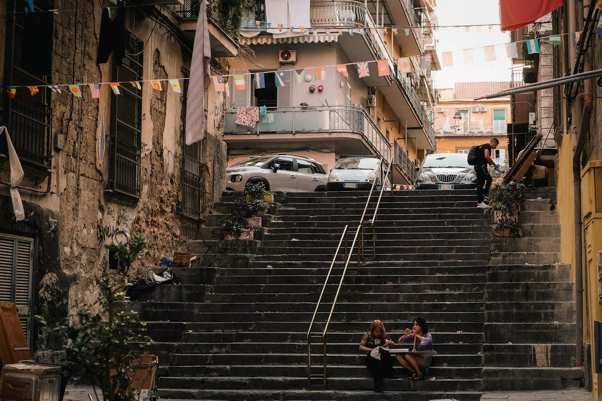 Stone staircase in Naples, Italy, lined with aged buildings, colorful facades, and wrought-iron balconies, capturing the charm of the city's layered architecture and hillside layout.
