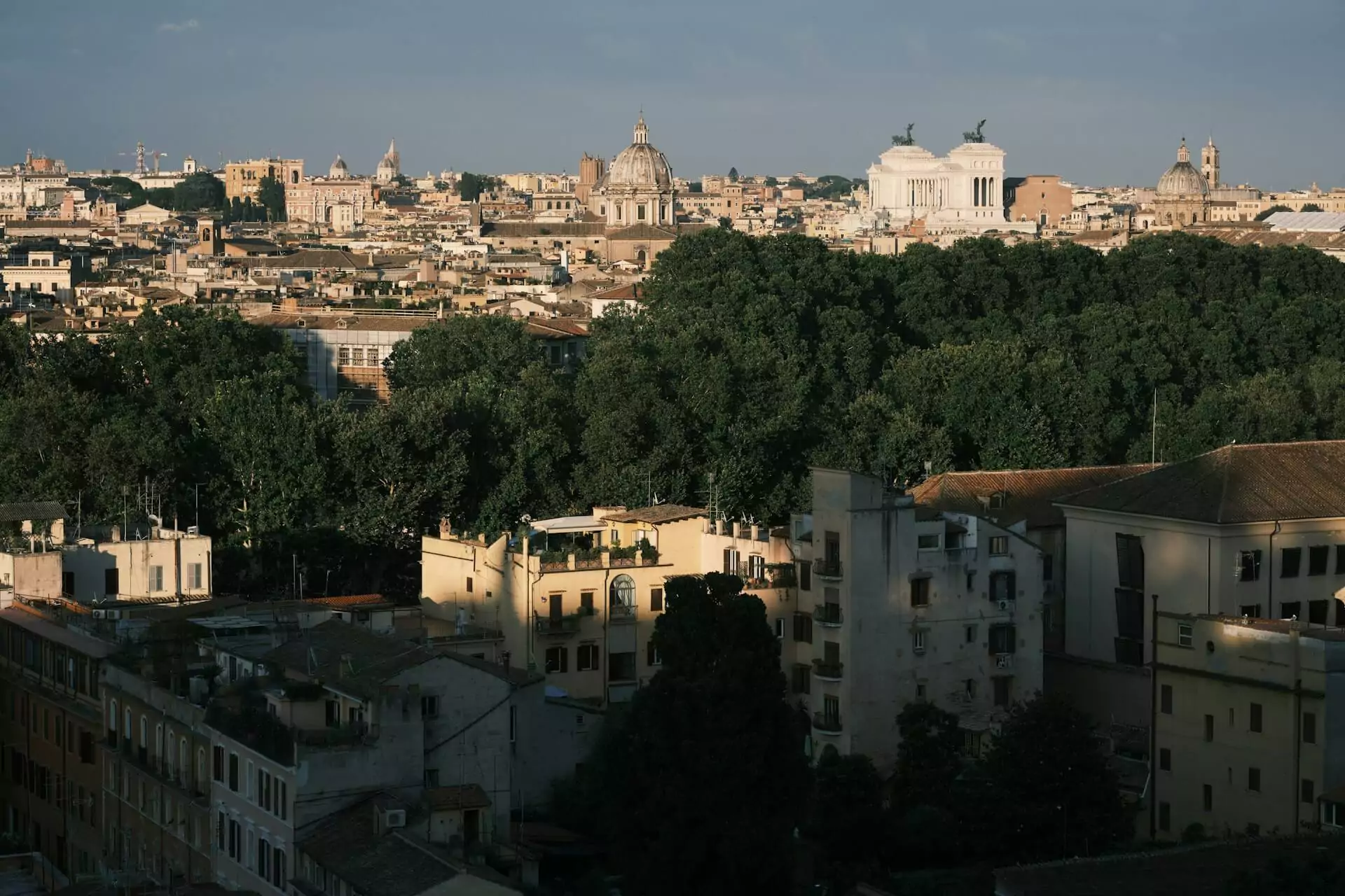 View of Rome’s cityscape from Gianicolo Hill, with historic rooftops, domes, and landmarks stretching across the horizon under a wide, clear sky, offering one of the best panoramic viewpoints in the city.