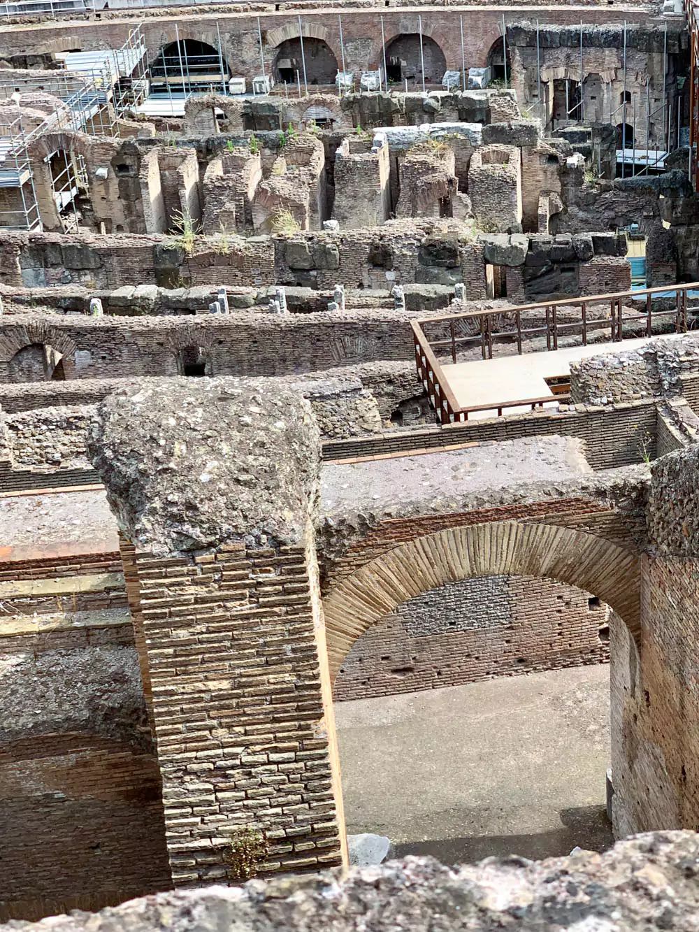 Close-up inside view of ancient brickwork in the Colosseum, highlighting the detailed texture, historical craftsmanship, and weathered appearance of the structure.