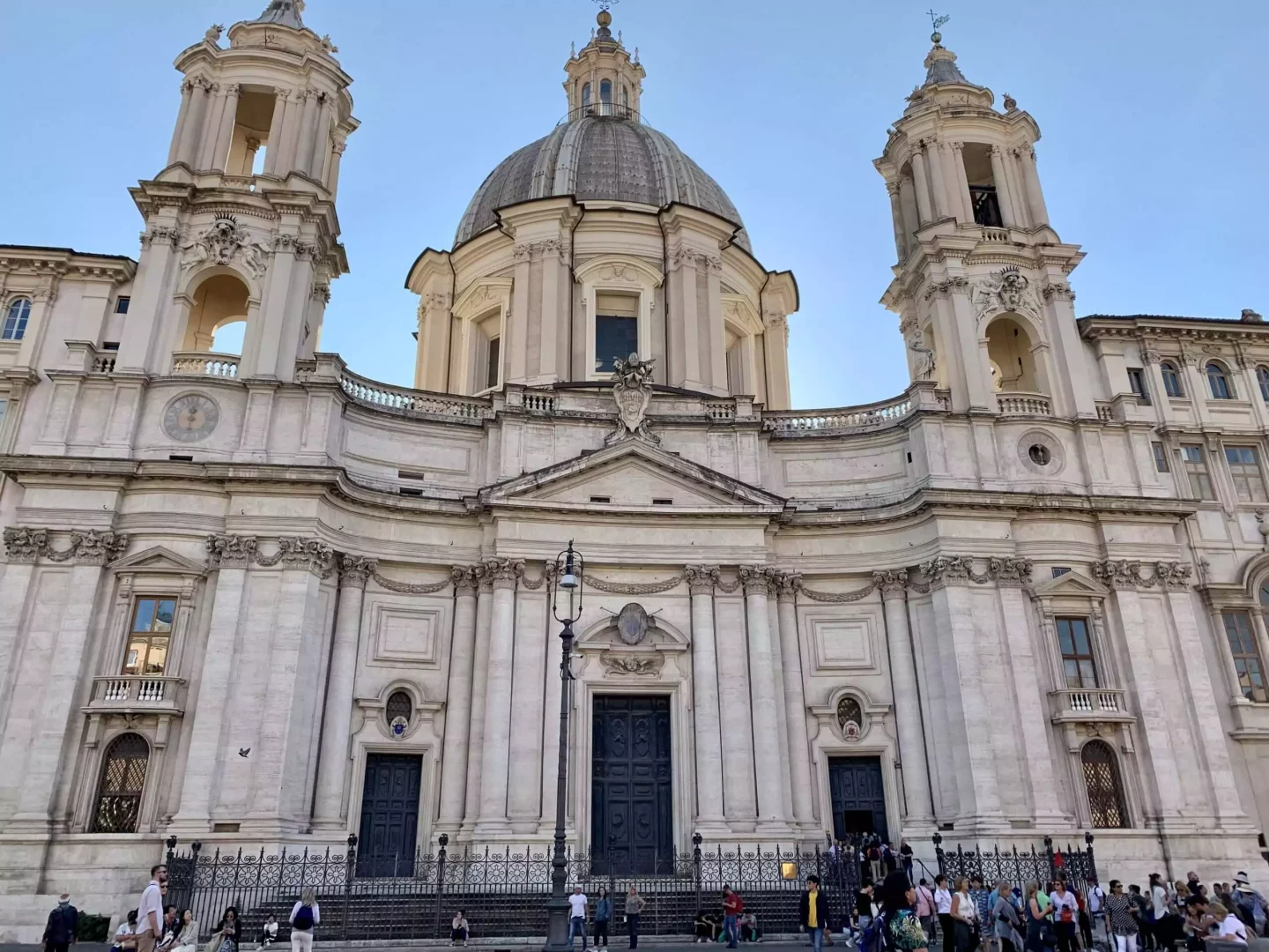 How To Plan The Perfect Italy Honeymoon: Sant’Agnese in Agone in Rome, Italy, with its grand Baroque facade and twin bell towers overlooking Piazza Navona. The church’s elegant architecture and central dome create a striking presence amid the vibrant city square.