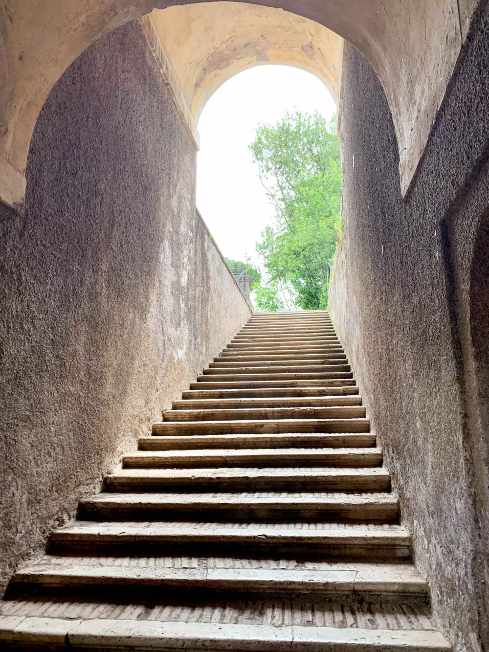 Ancient stone staircase at the Roman Forum in Rome, Italy, leading visitors through the historic ruins, surrounded by remnants of temples, columns, and worn pathways from the Roman Empire.