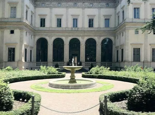 Courtyard at Villa Farnesina in Rome, featuring elegant arches, frescoed walls, and a peaceful open-air space surrounded by Renaissance architecture and lush greenery.