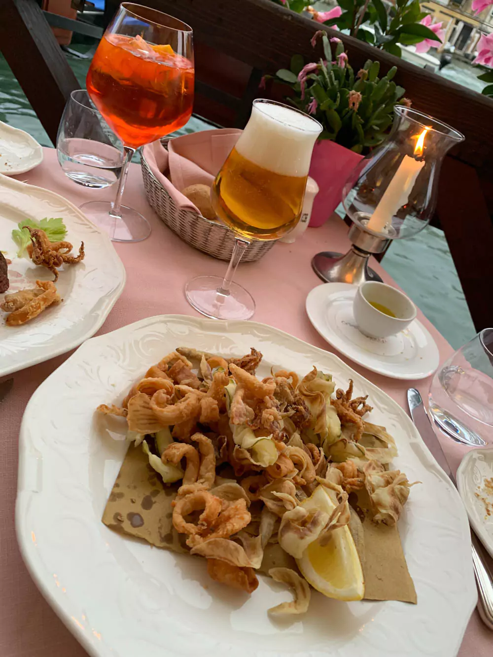 Fish and chips dinner served at Ca’ Sagredo Hotel in Venice, Italy, featuring golden fried fish fillets with crispy chips on an elegant plate, set in a refined dining space with Venetian charm — a classic-meets-contemporary meal