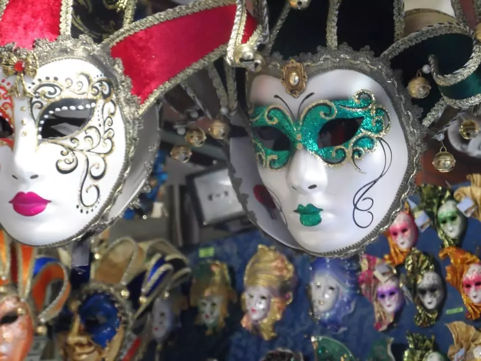 Display of colorful Venetian masks featuring intricate designs, feathers, gold accents, and elaborate detailing, capturing the festive and artistic spirit of Venice’s famous Carnival tradition.
