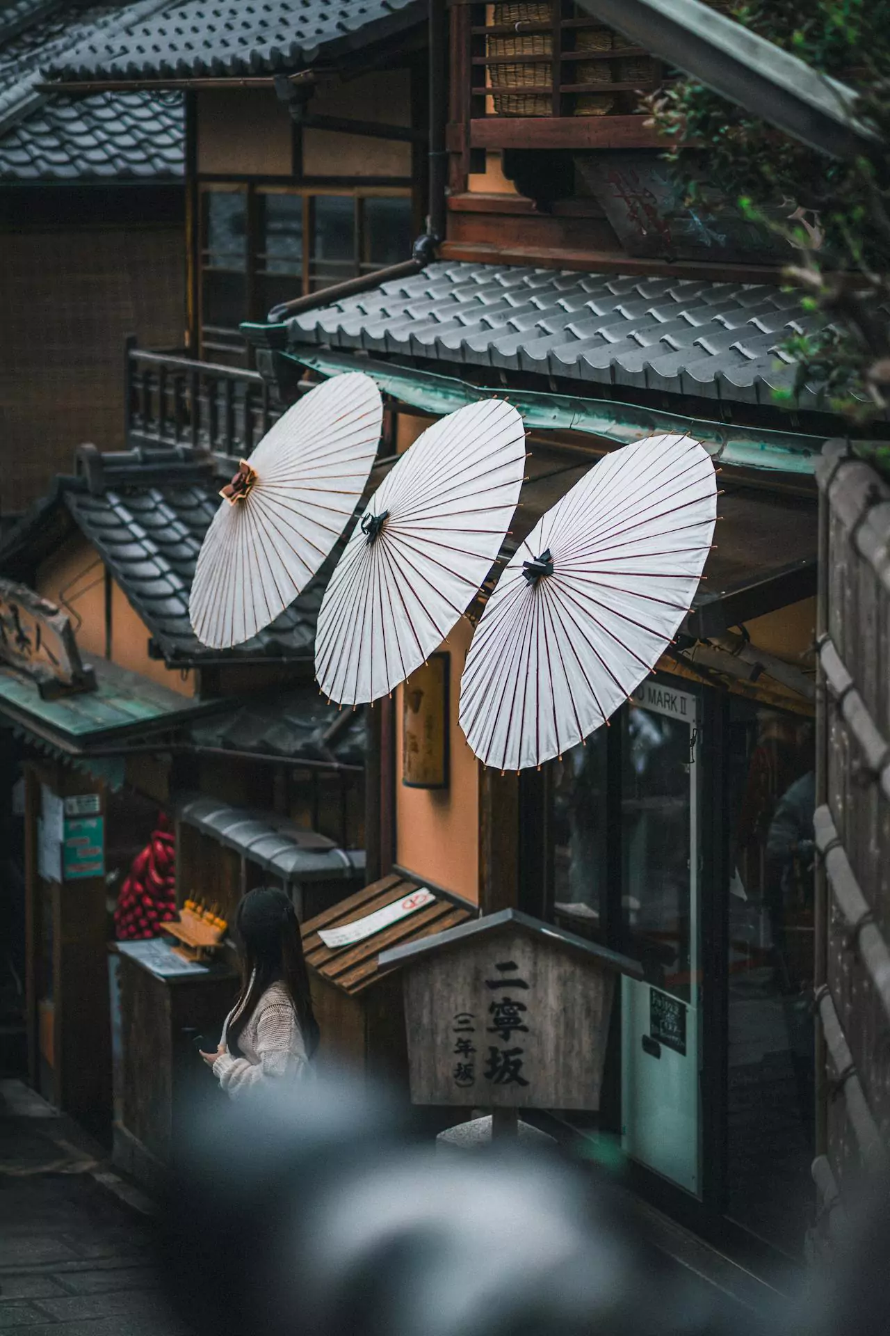 Umbrella's hanging off of side of building in Kyoto