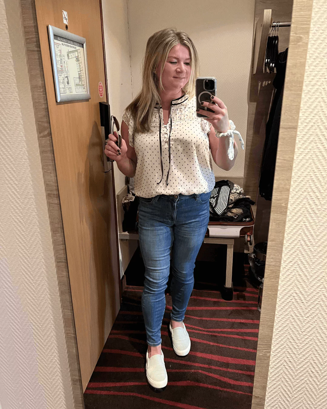 Katie dressed for a visit to Neuschwanstein Castle in Germany, wearing skinny jeans, slip-on sneakers, and a polka dot blouse—comfortable and stylish for exploring the Bavarian landmark.