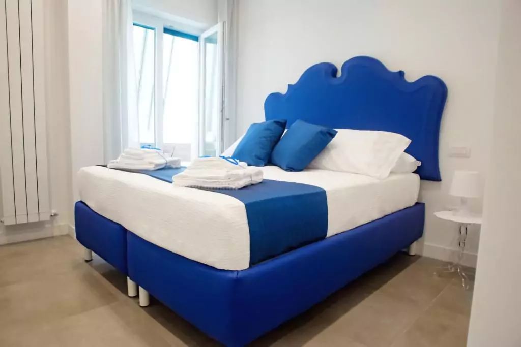 Kerbaker 14 in Naples, Italy, featuring a modern, well-lit guest room with contemporary decor and clean lines, set in the vibrant Vomero district