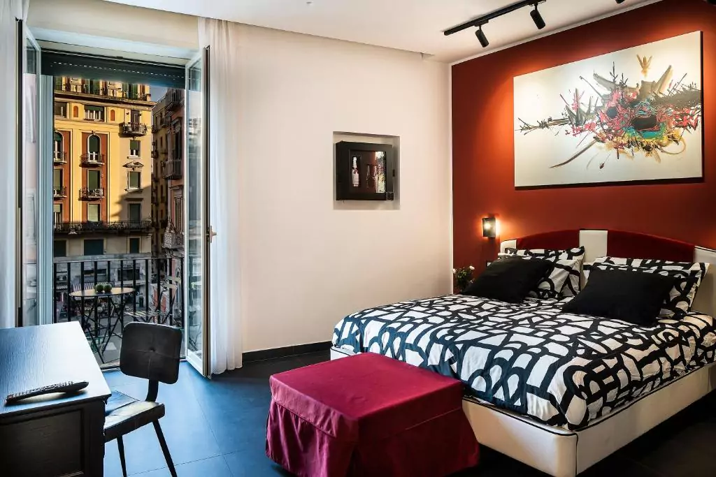 Le Stanze del Barone in Naples, Italy, featuring a classically styled guest room with rich colors, antique furnishings, and high ceilings — a charming and historic stay