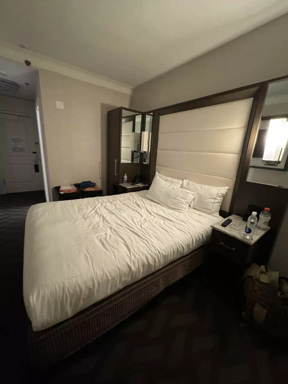 Wicked Queen-themed bed at Hilton Boston, dressed in crisp white sheets with a tufted headboard and elegant decor creating a bold, regal atmosphere.