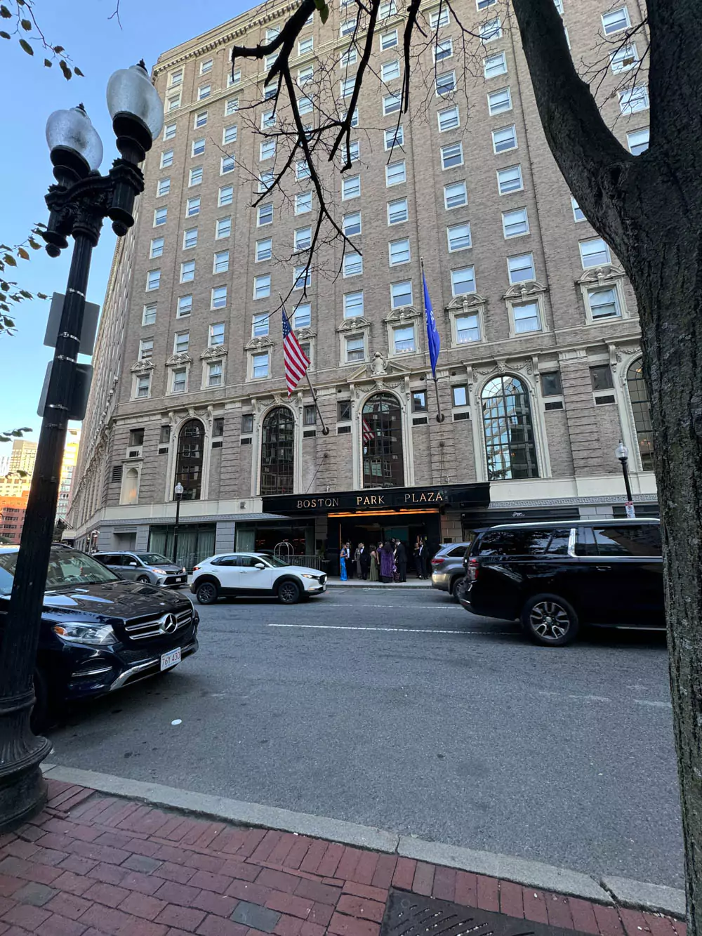 Exterior of Hilton Boston Park Plaza, a historic hotel with classic architecture, grand entrance, and American flags above the doorway in the heart of Back Bay.