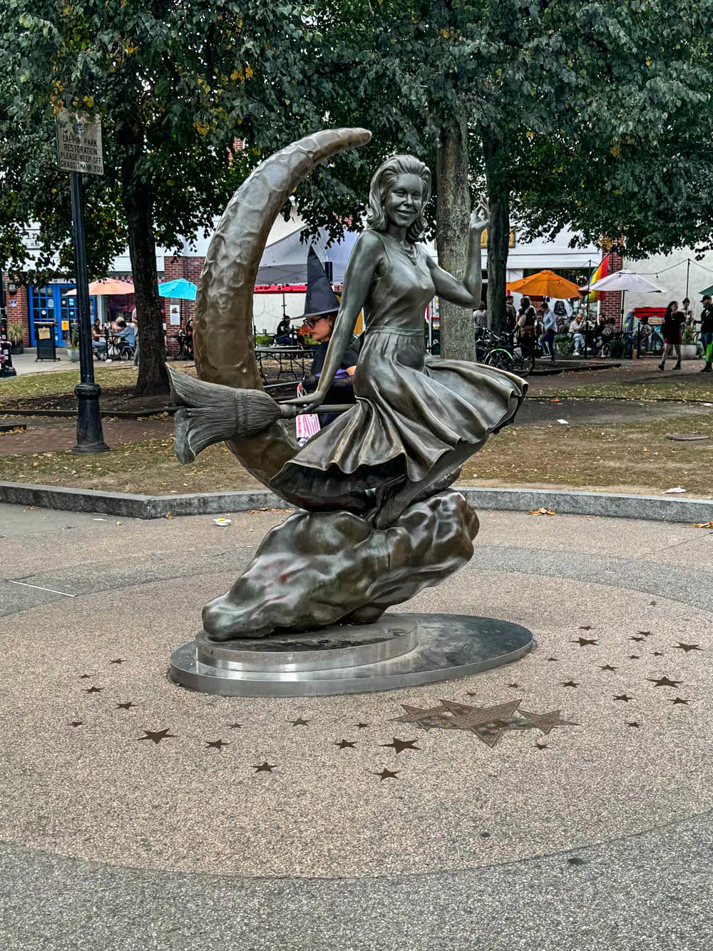 Bewitched statue in Salem, Massachusetts, featuring a bronze sculpture of Samantha Stephens from the classic TV show, sitting on a crescent moon. Set in a small plaza, the whimsical tribute reflects Salem’s pop culture connection to witchcraft.