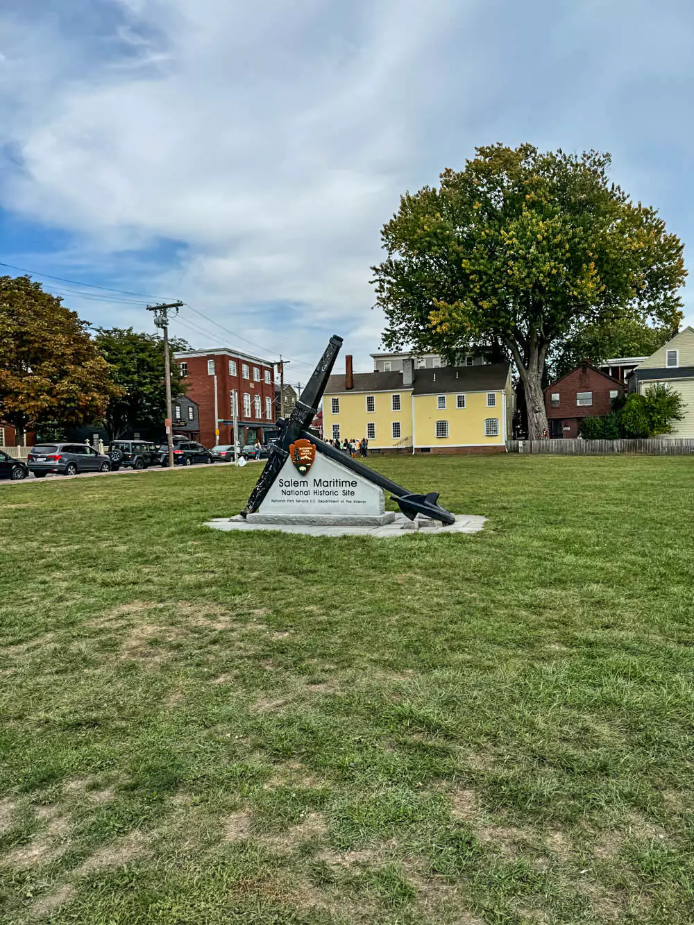 Salem Maritime National Historic Site, featuring restored colonial-era buildings along the waterfront with wooden piers and historic ships. The site preserves Salem’s role in early American trade and maritime history.