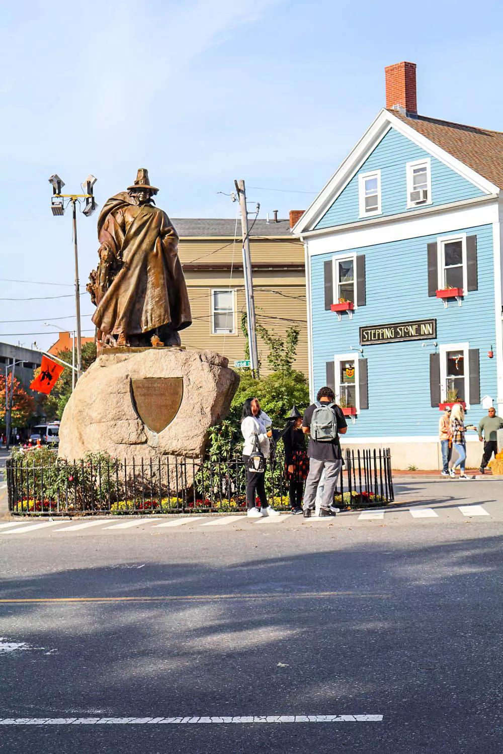 Statue of Roger Conant, founder of Salem, Massachusetts, featuring a cloaked figure standing on a stone pedestal with a stern expression. The bronze sculpture overlooks the city, symbolizing its Puritan roots and early colonial history.