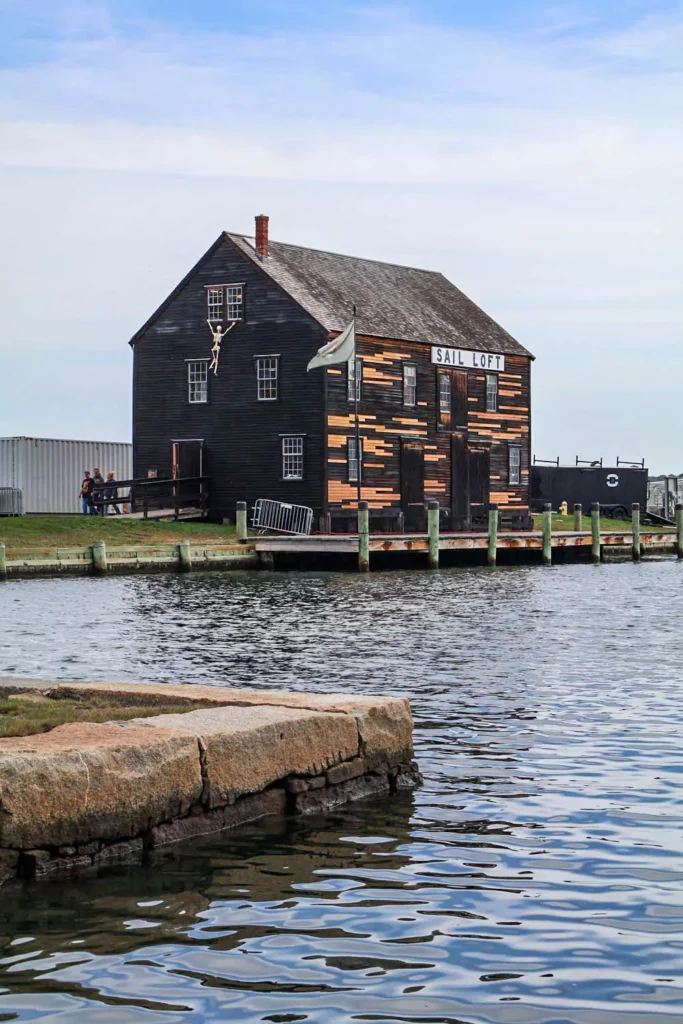 The Sail House in Salem, Massachusetts, showcasing a classic New England facade with white clapboard siding, black shutters, and a pitched roof. The historic building reflects Salem’s maritime heritage and colonial architecture.