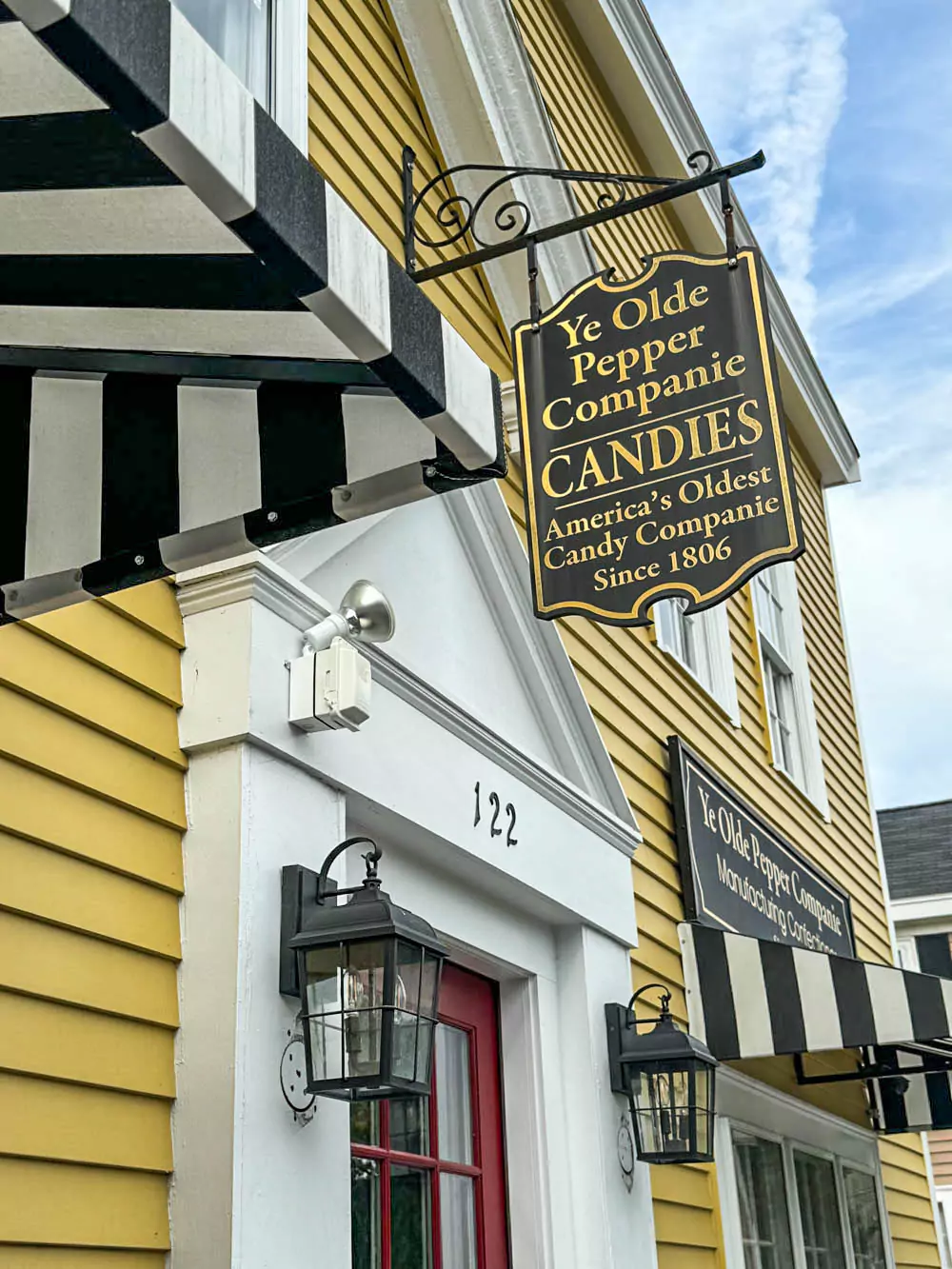 Sign for Ye Olde Pepper Companie in Salem, Massachusetts, featuring vintage-style lettering and a hanging wooden board. Known as America’s oldest candy company, the shop blends sweet tradition with colonial charm.