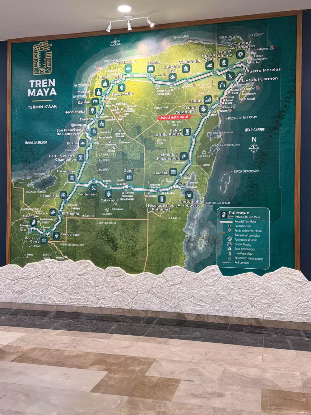 of Tulum, Mexico, highlighting major areas and attractions such as the Tulum Ruins, beaches, cenotes, hotel zone, and downtown, with colorful drawings and labeled icons.