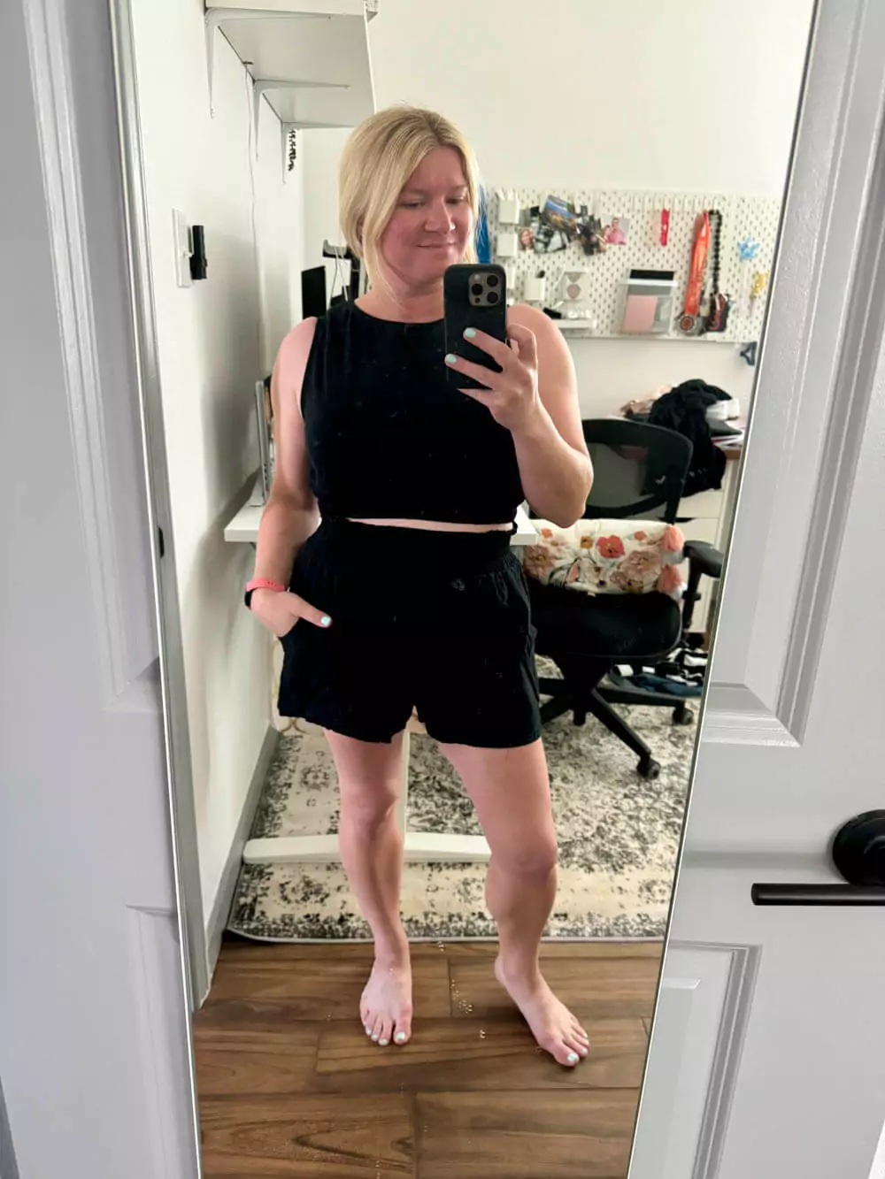 Black sleeveless crop top and high-waisted shorts.