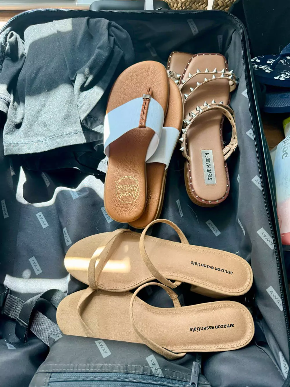 Three pairs of sandals: white, embellished, and block heel sandals for versatile beach and casual wear.
