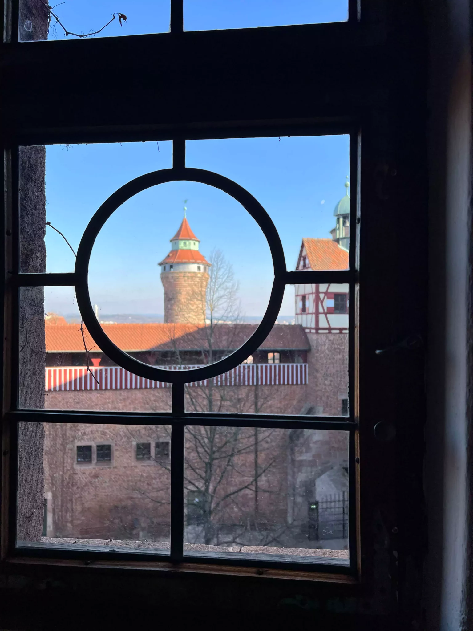 A Castle Tower in the distance outside a decorative window