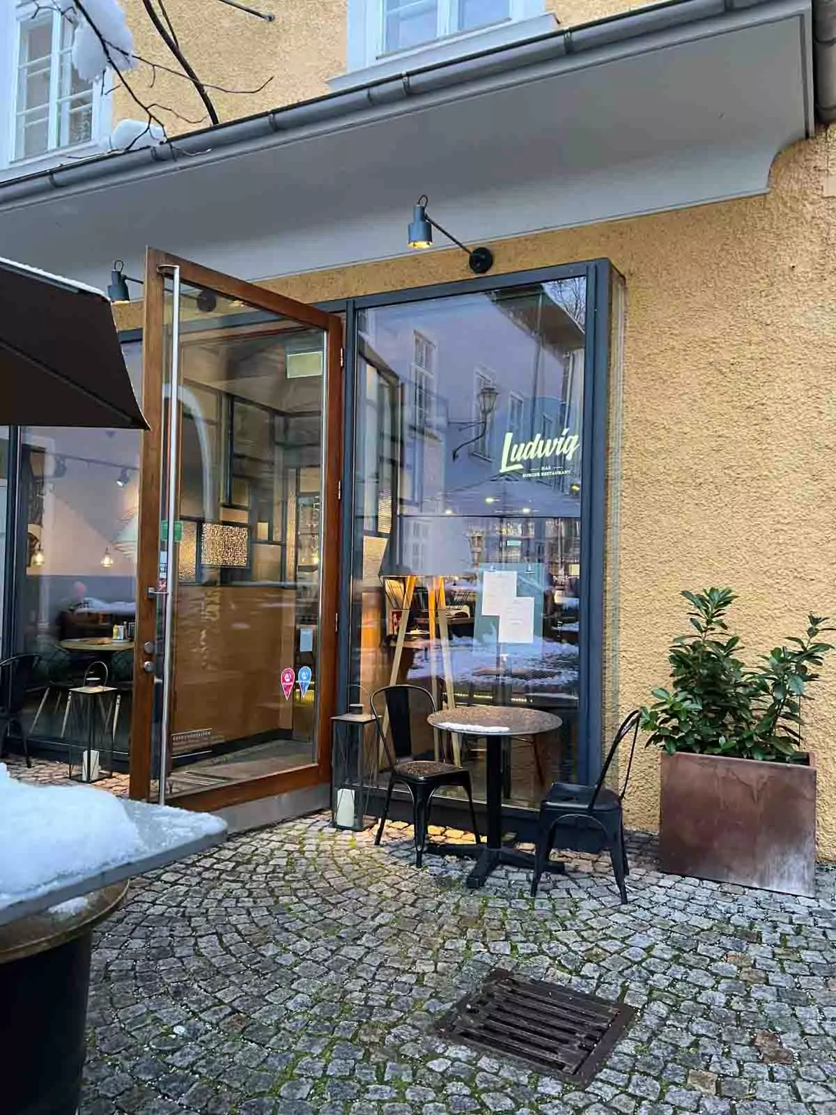 Exterior of Ludwig restaurant in Salzburg, Austria, featuring a modern storefront with clean signage, large windows, and a welcoming vibe along a charming city street.